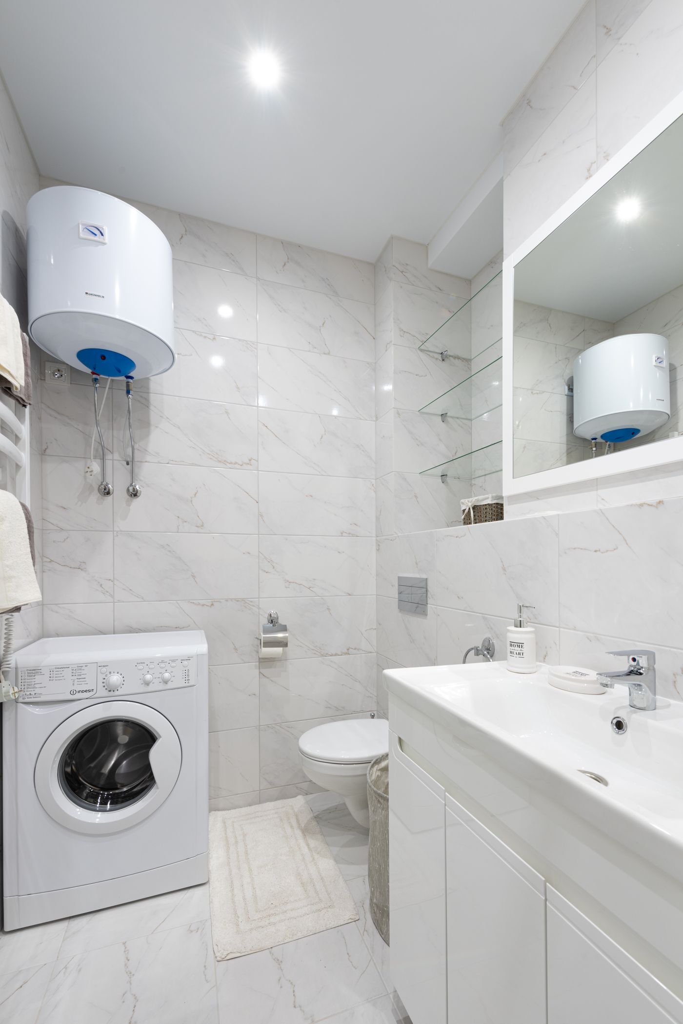 Wall-mounted water heater tank in a bright bathroom