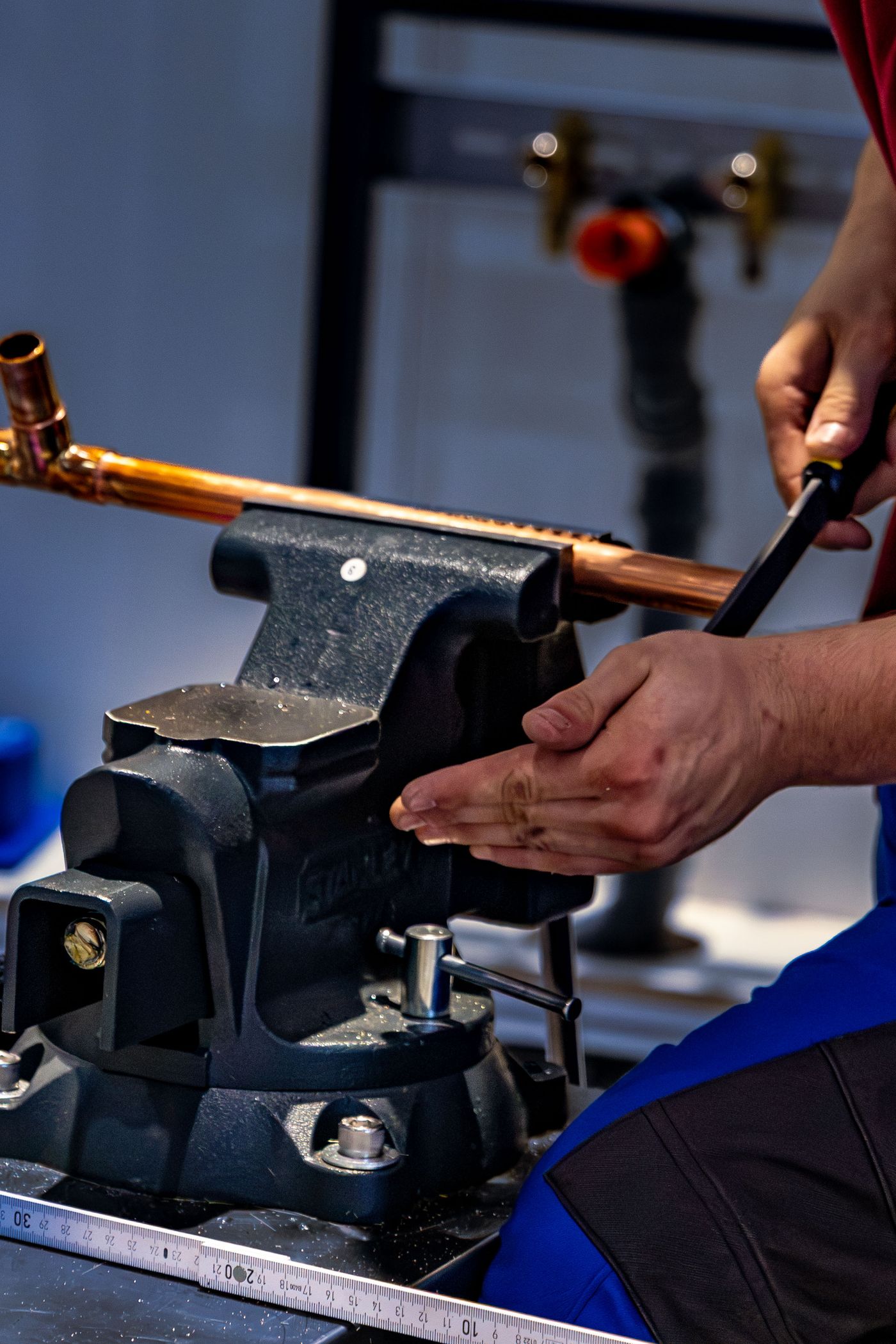 Copper pipe held in a bench vise during repair work