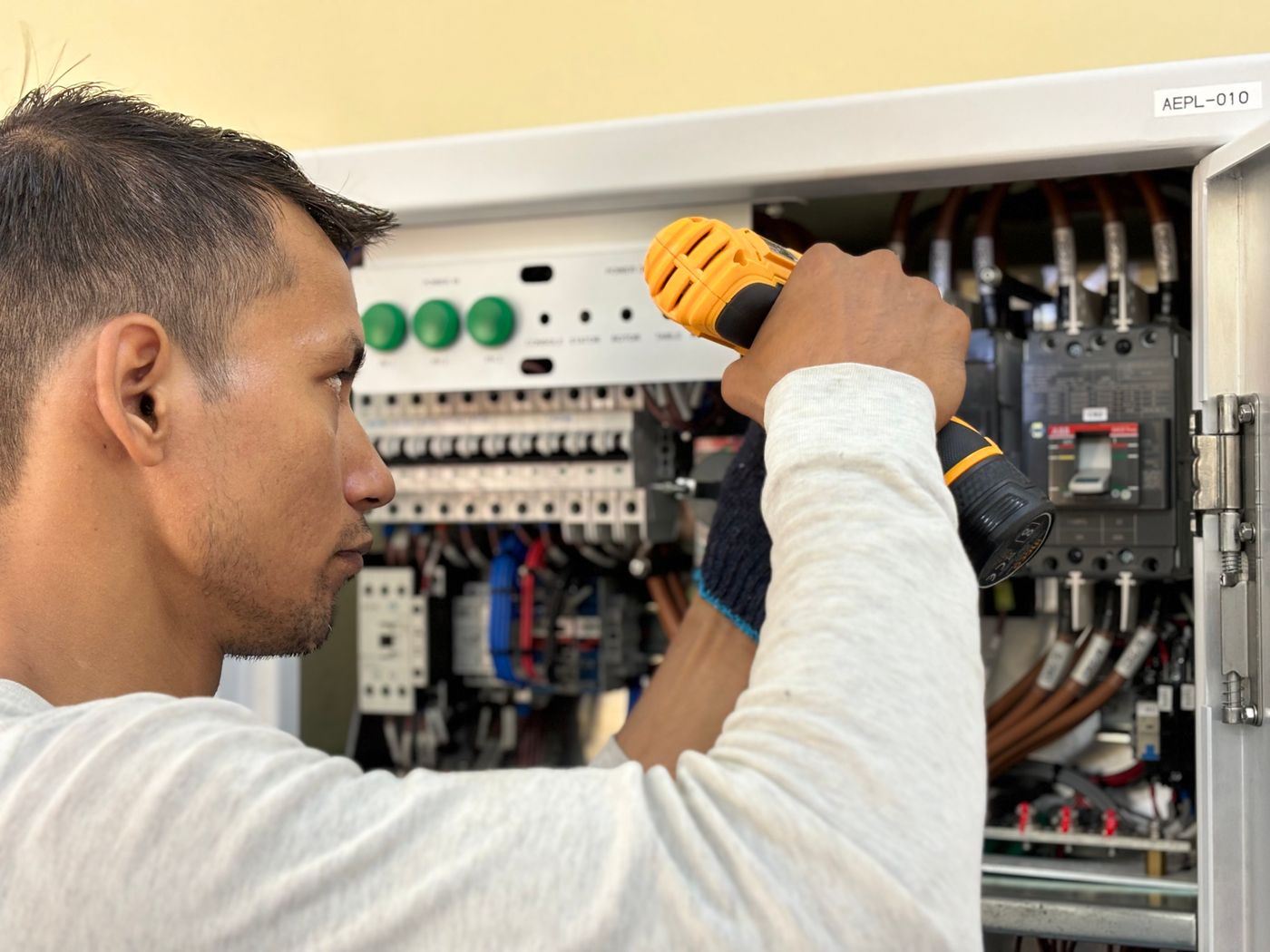 Technician working at an electrical panel