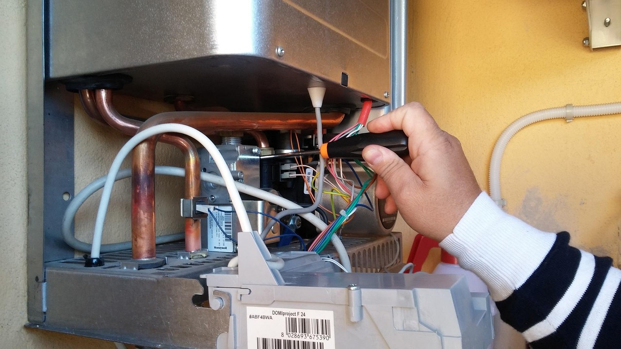 Technician checking the wiring and controls of a wall-mounted unit